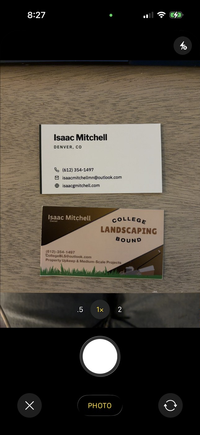 Taking a photo of two business cards laid out on a table in CardScanner