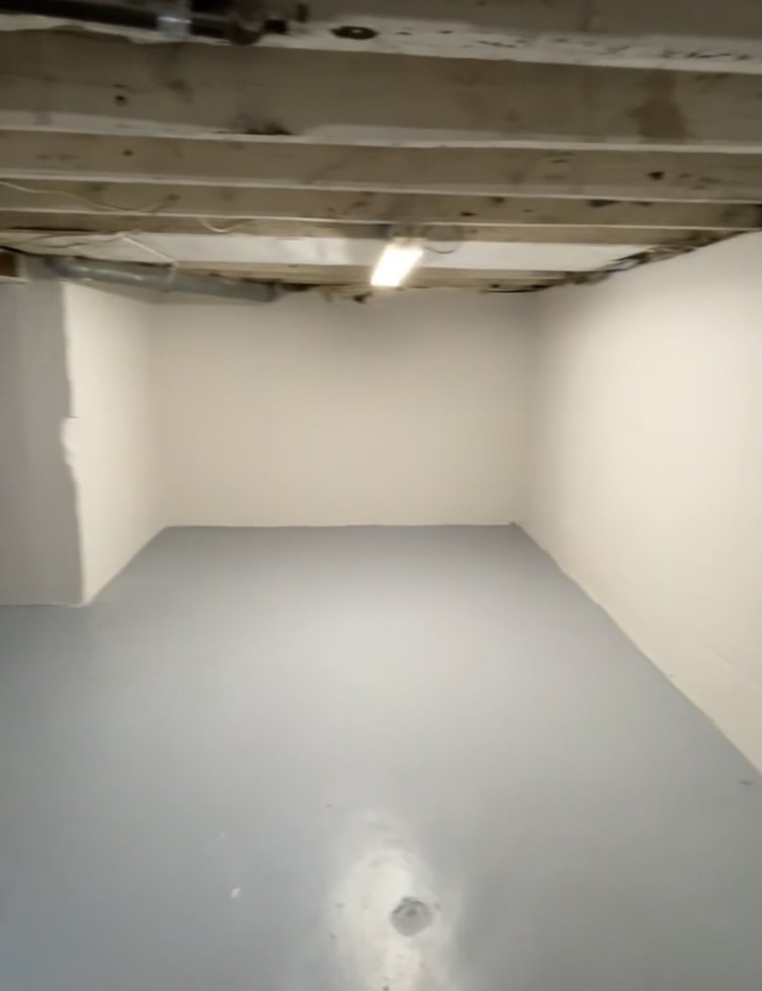 Basement room after pressure washing and painting the walls and floor