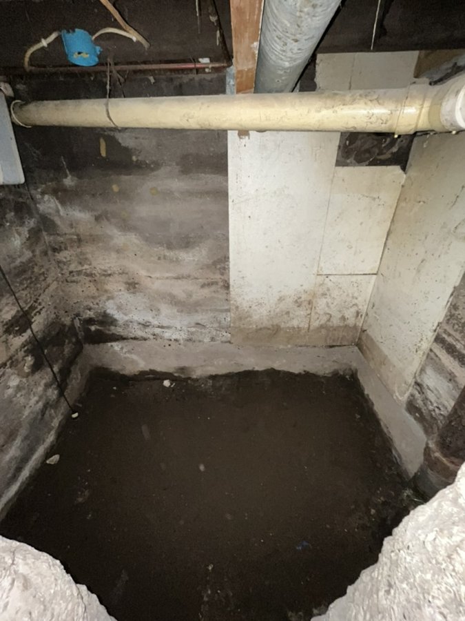 Dirt floor room in the basement before pouring concrete
