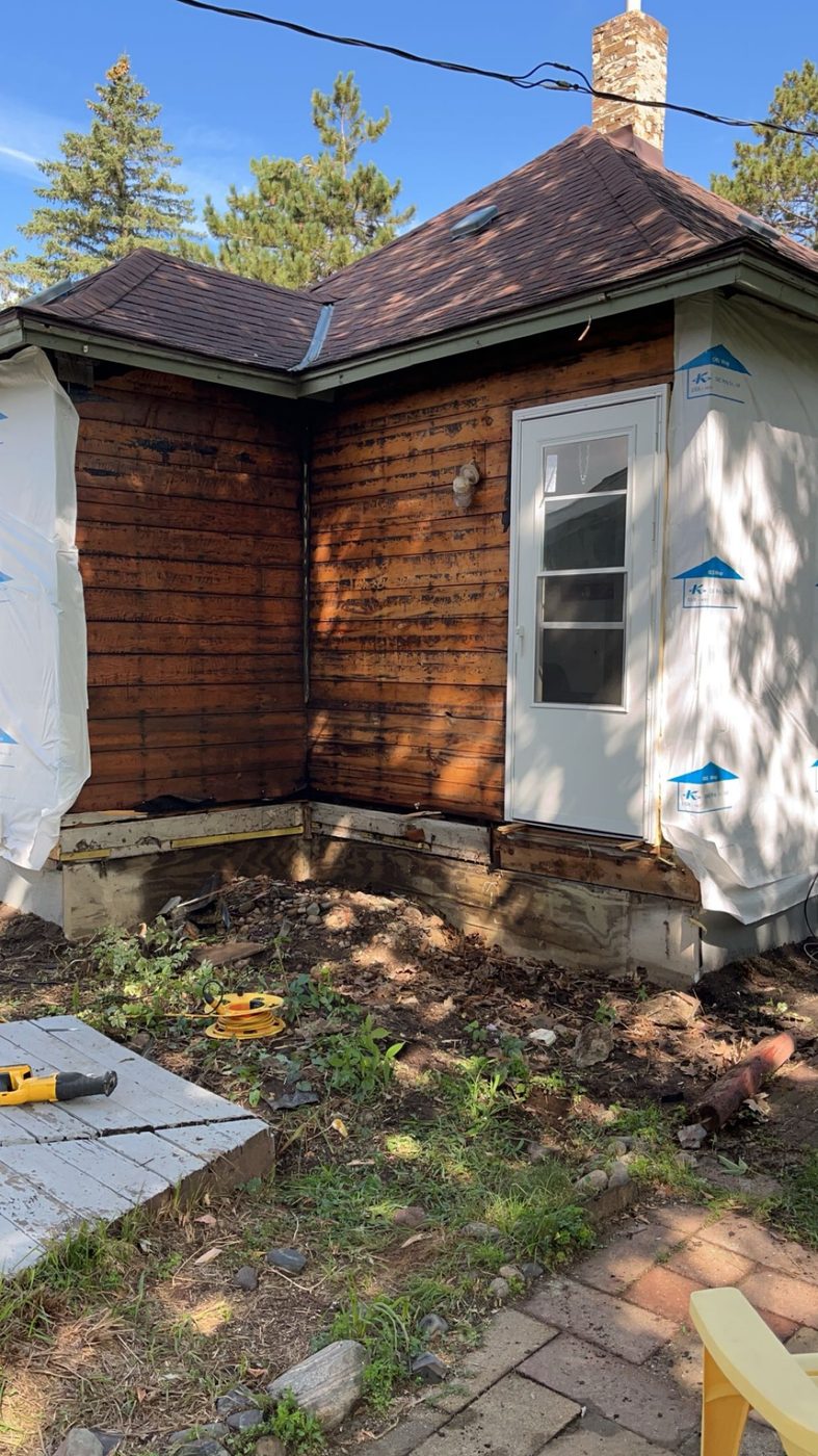 House mid-reside, old wood siding next to new siding