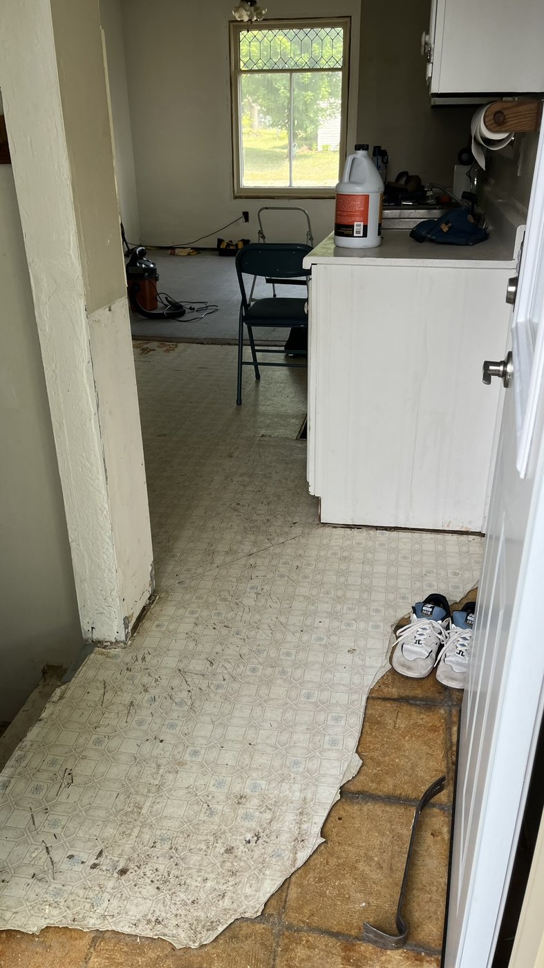 Original flooring in the kitchen and dining area before demo
