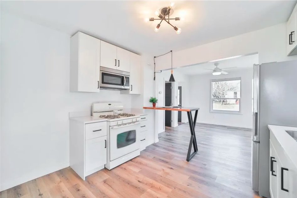 Finished kitchen with stove and dining nook from the listing