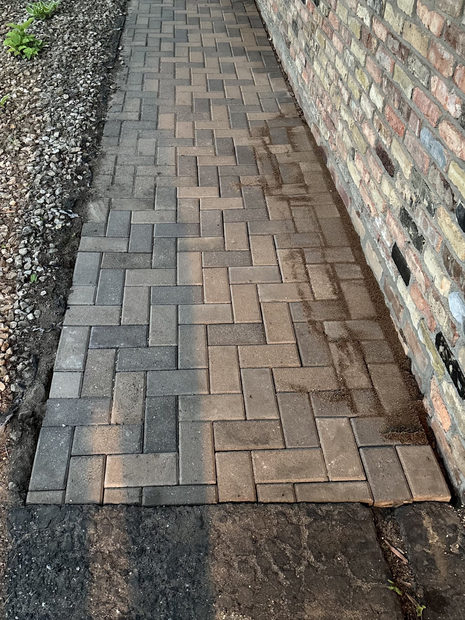 Reference photo of a traditional herringbone brick paver style, not a photo from this project